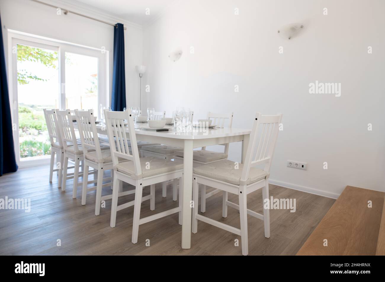 Contemporary dining room with white walls and white table and chairs Stock Photo