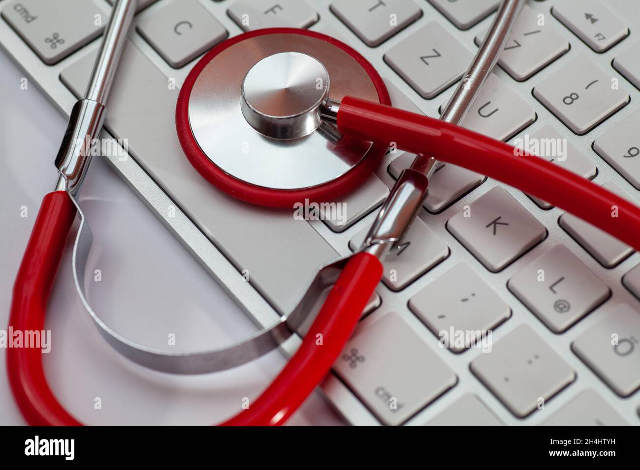 Red doctor's stethoscope on a computer keyboard Stock Photo - Alamy