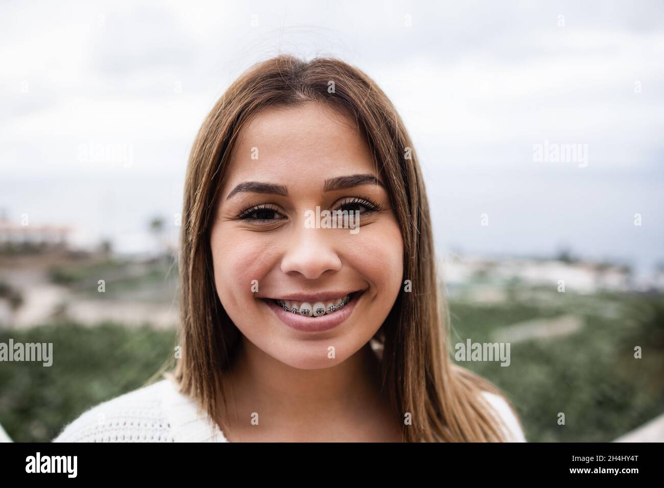 Young latin girl smiling on camera outdoor - Focus on face Stock Photo ...