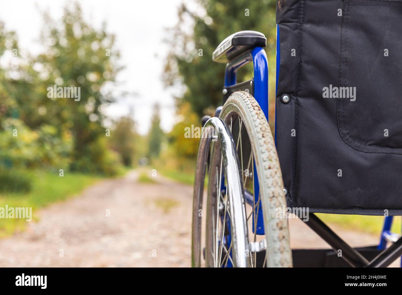 Empty wheelchair standing on road waiting for patient services. Wheel ...
