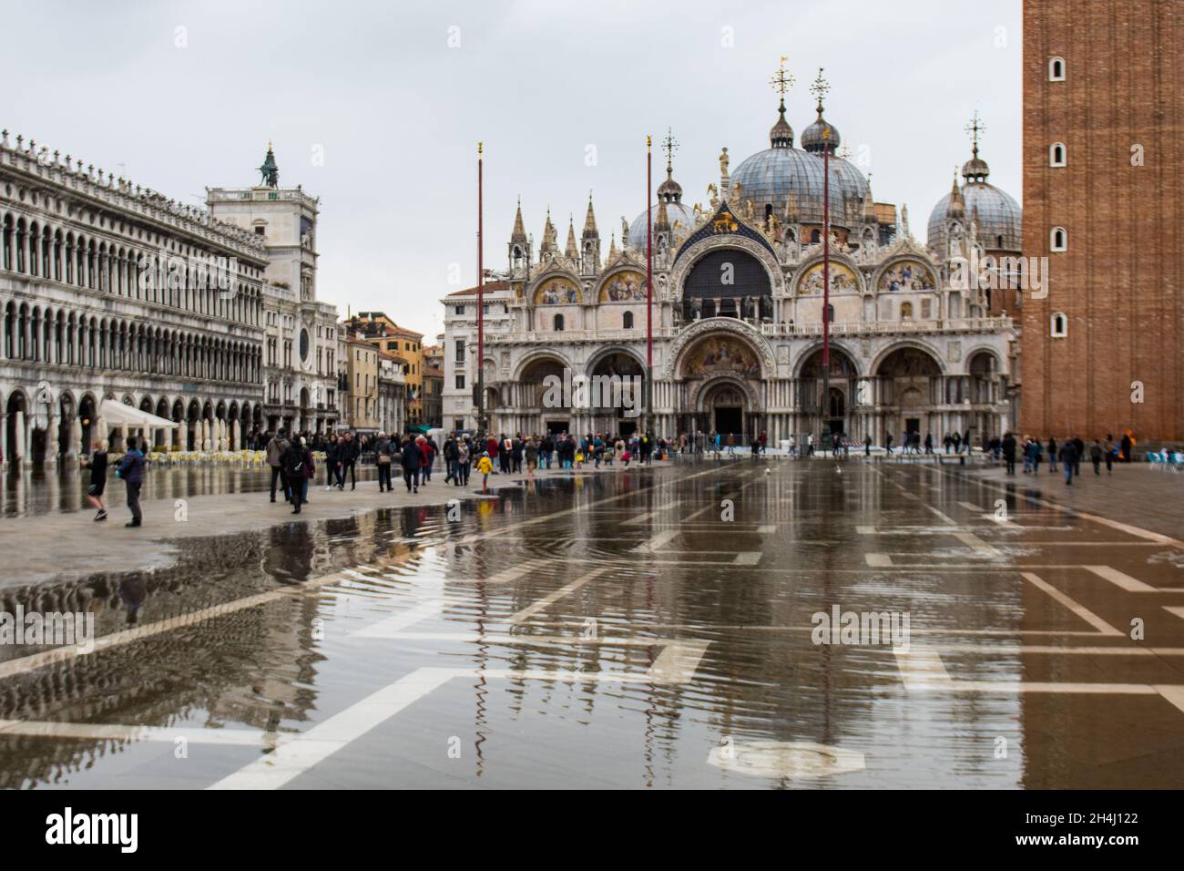 Venice, Italy. 03rd November, 2021. Tourists walk in a flooded St. Mark square during an high tide on November 3, 2021 in Venice, Italy. In these days Venice is under water due to the high level of the tide for climate change, and Mose is activated, but not sufficient. © Simone Padovani / Awakening / Alamy Live News Stock Photo