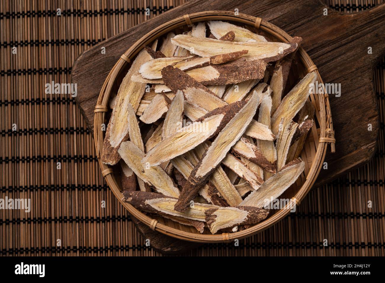 Top view of Chinese traditional herbal medicine Astragalus root on wooden table background. Stock Photo