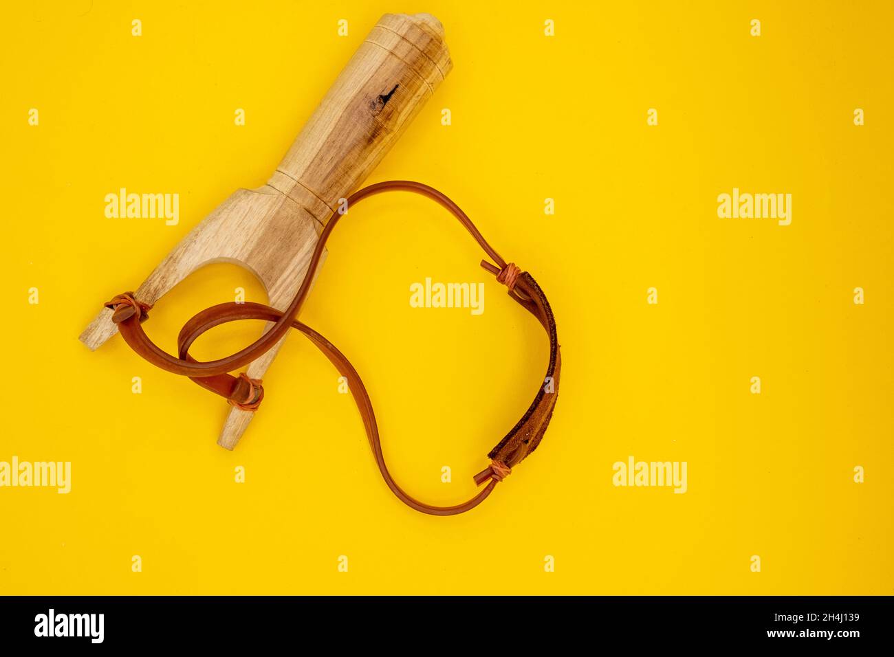 Slingshot handmade toy made of wood, leather and rubber. Tirachinas. Stock Photo