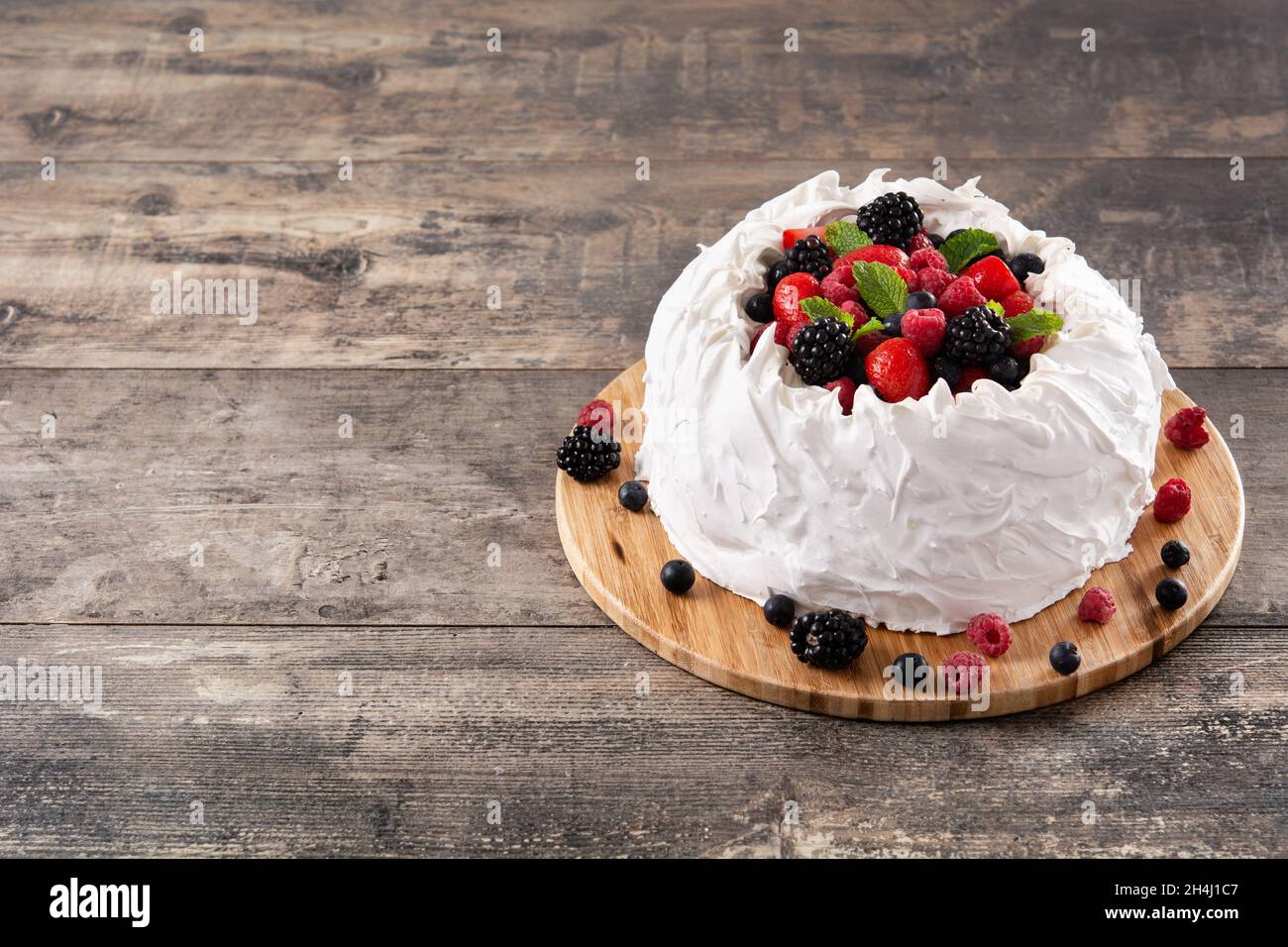 Delicious Pavlova cake with meringue topped and fresh berries Stock Photo
