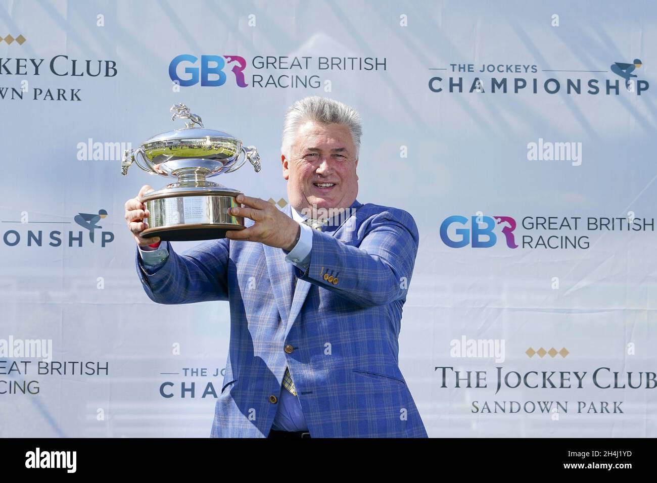 File photo dated 24-04-2021 of Paul Nicholls with his Champion Trainer trophy for the national hunt season 2020-21. Paul Nicholls is priming Enrilo for a crack at the £250,000 Ladbrokes Trophy at Newbury later this month. Issue date: Wednesday November 3, 2021. Stock Photo