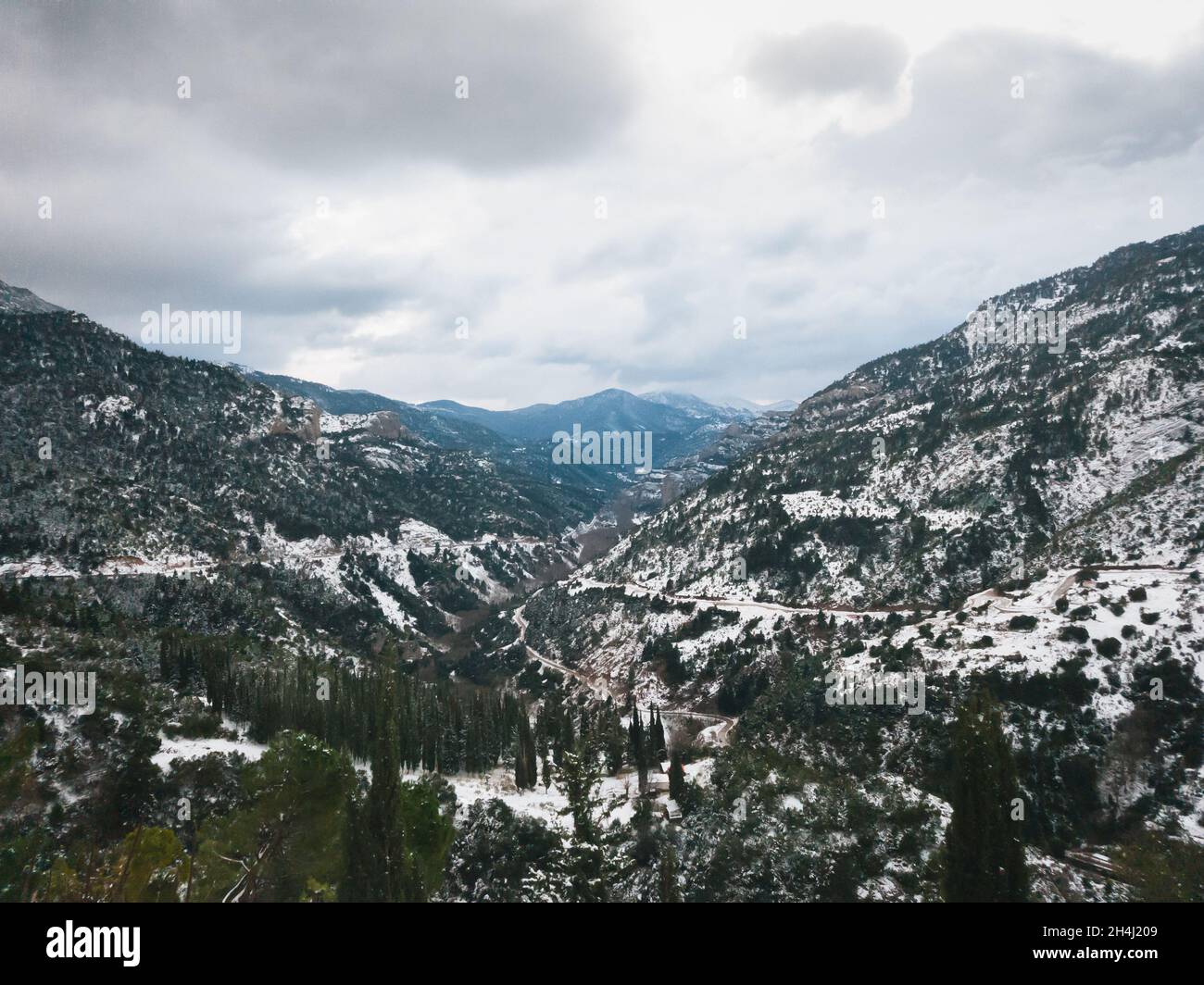 Aerial view at Vouraikos gorge with Diakopto-Kalavryta rack railway running down through canyon. Top view from Mega Spileon Monastery. Popular winter travel destination in Kalavryta, Greece, Europe Stock Photo