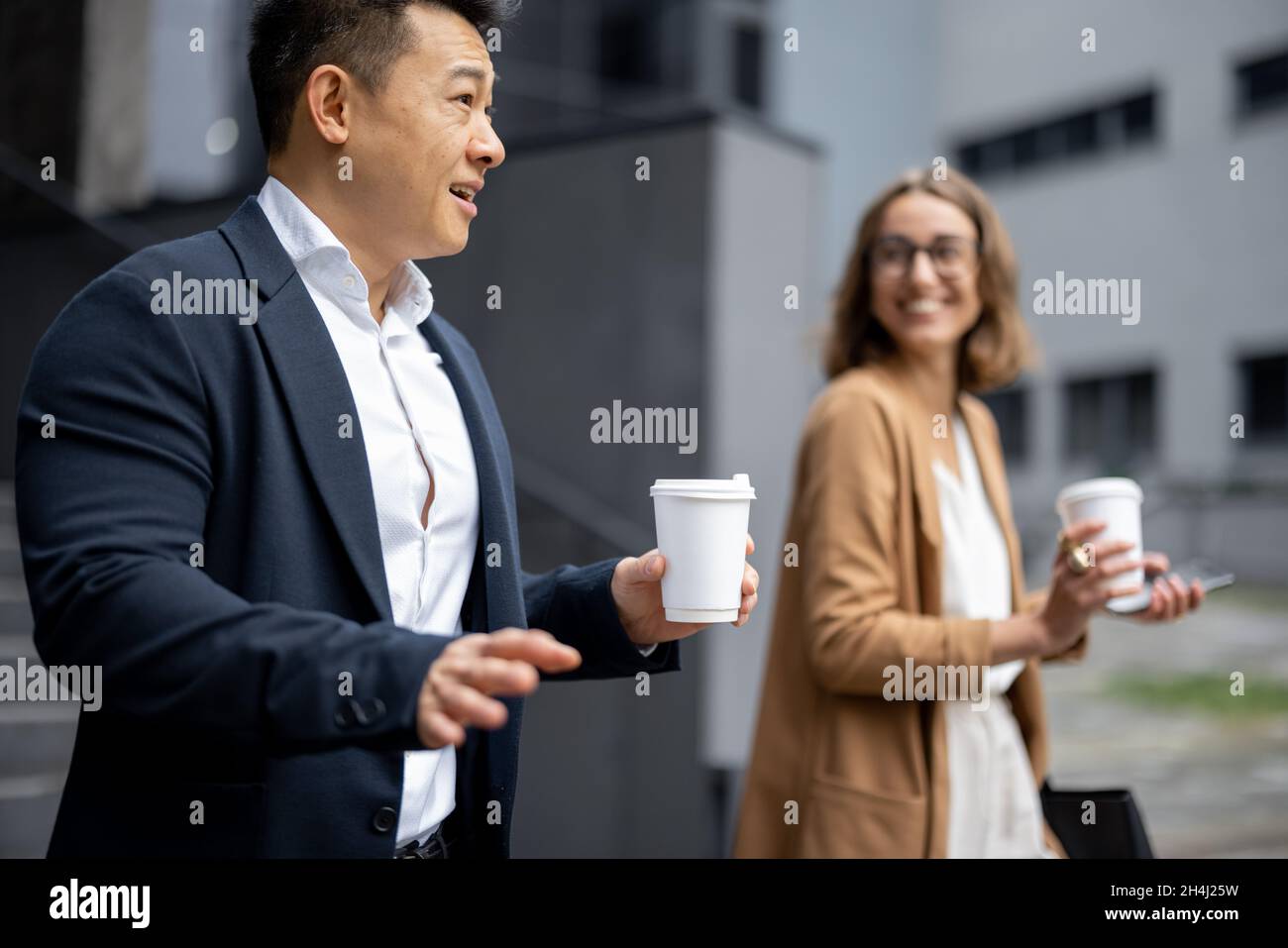 Business people walking and talking in city Stock Photo - Alamy