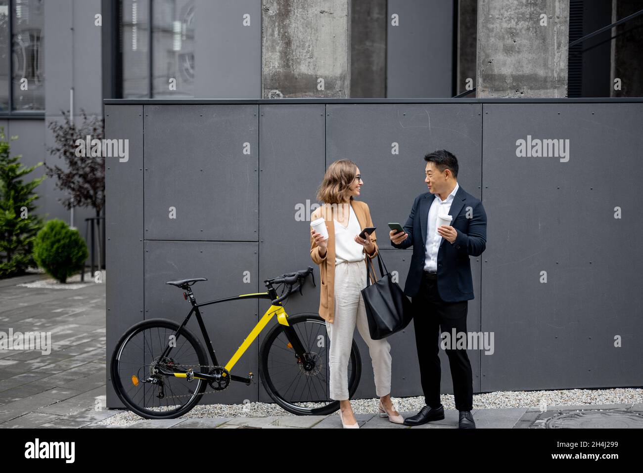 Business people drinking coffee and using phones Stock Photo