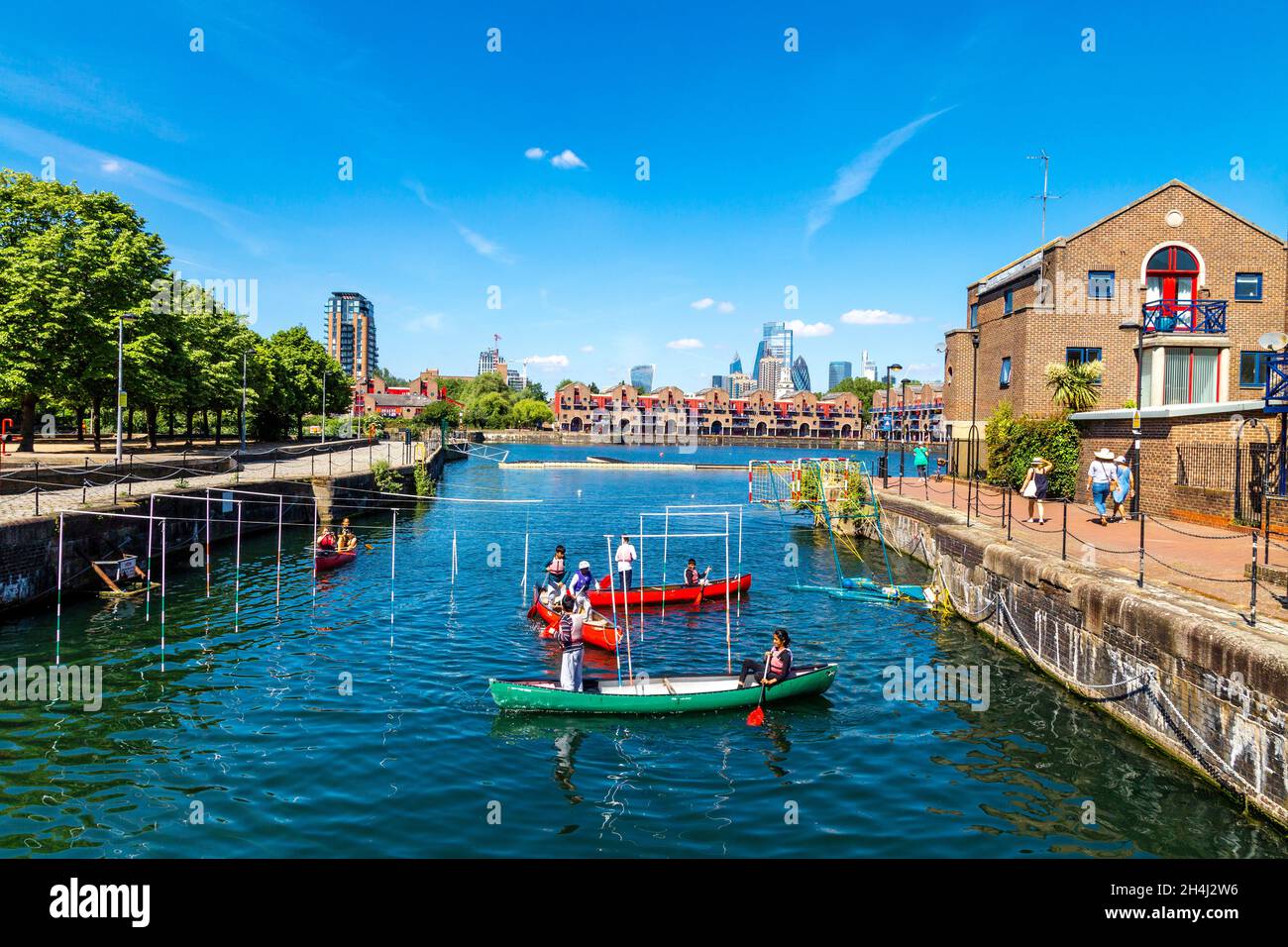 People canoeing in a canoe slalom at the Shadwell Basin Outdoor Activity Centre, London, UK Stock Photo