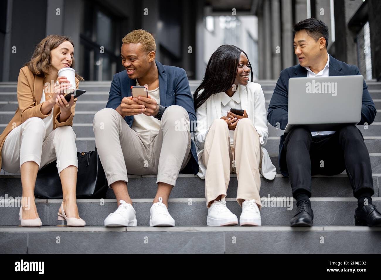 Business team talking and using digital devices Stock Photo