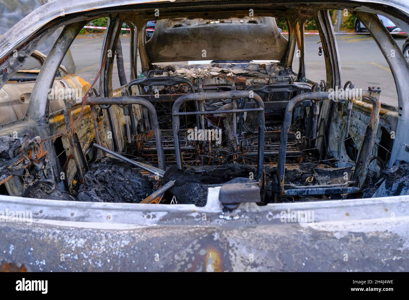 broken car's interior wreck. Burnt car's seats in the street. Riot, civil protest, hooliganism Stock Photo