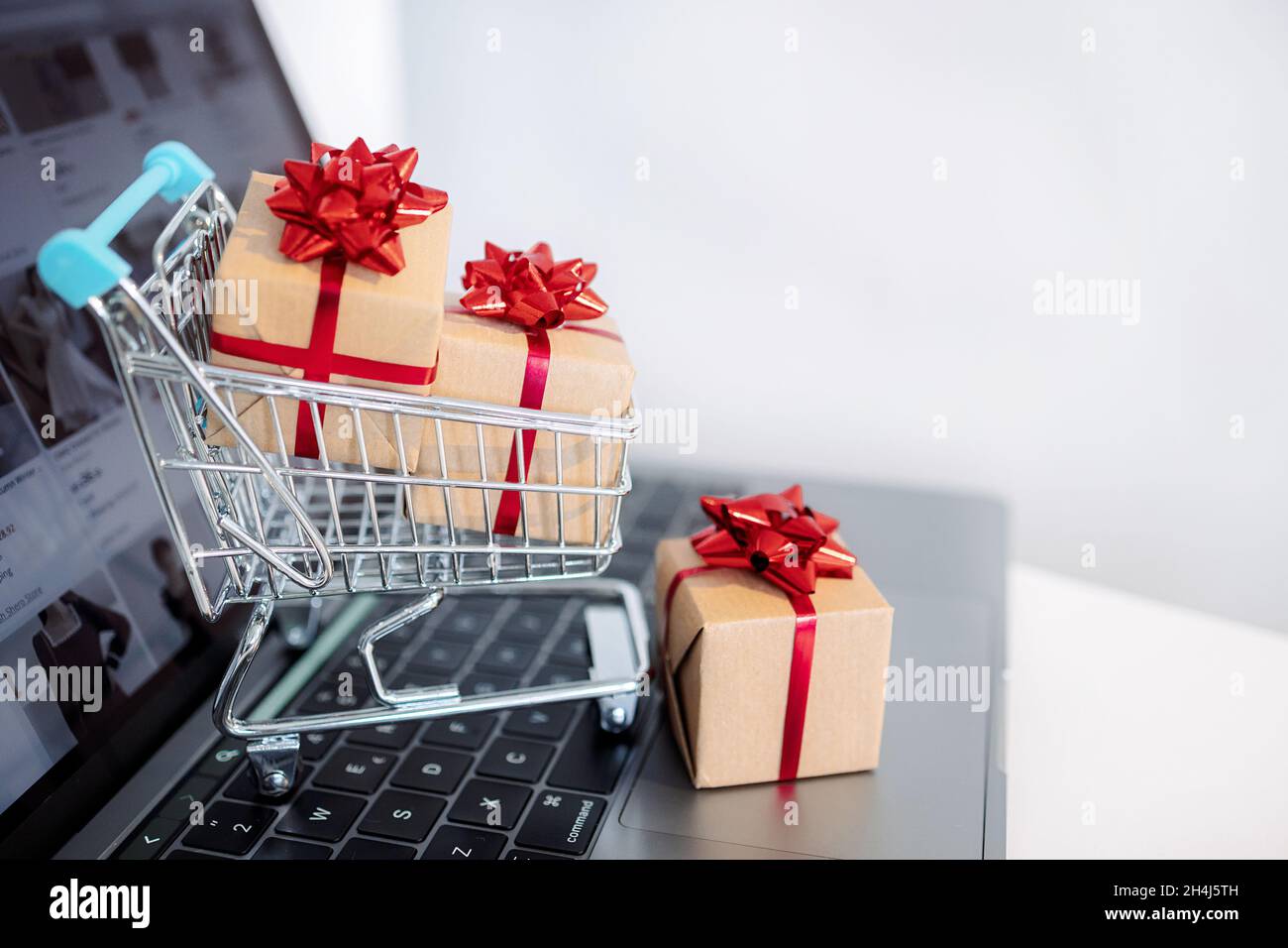 The concept online shopping. Laptop and small shopping cart. Christmas