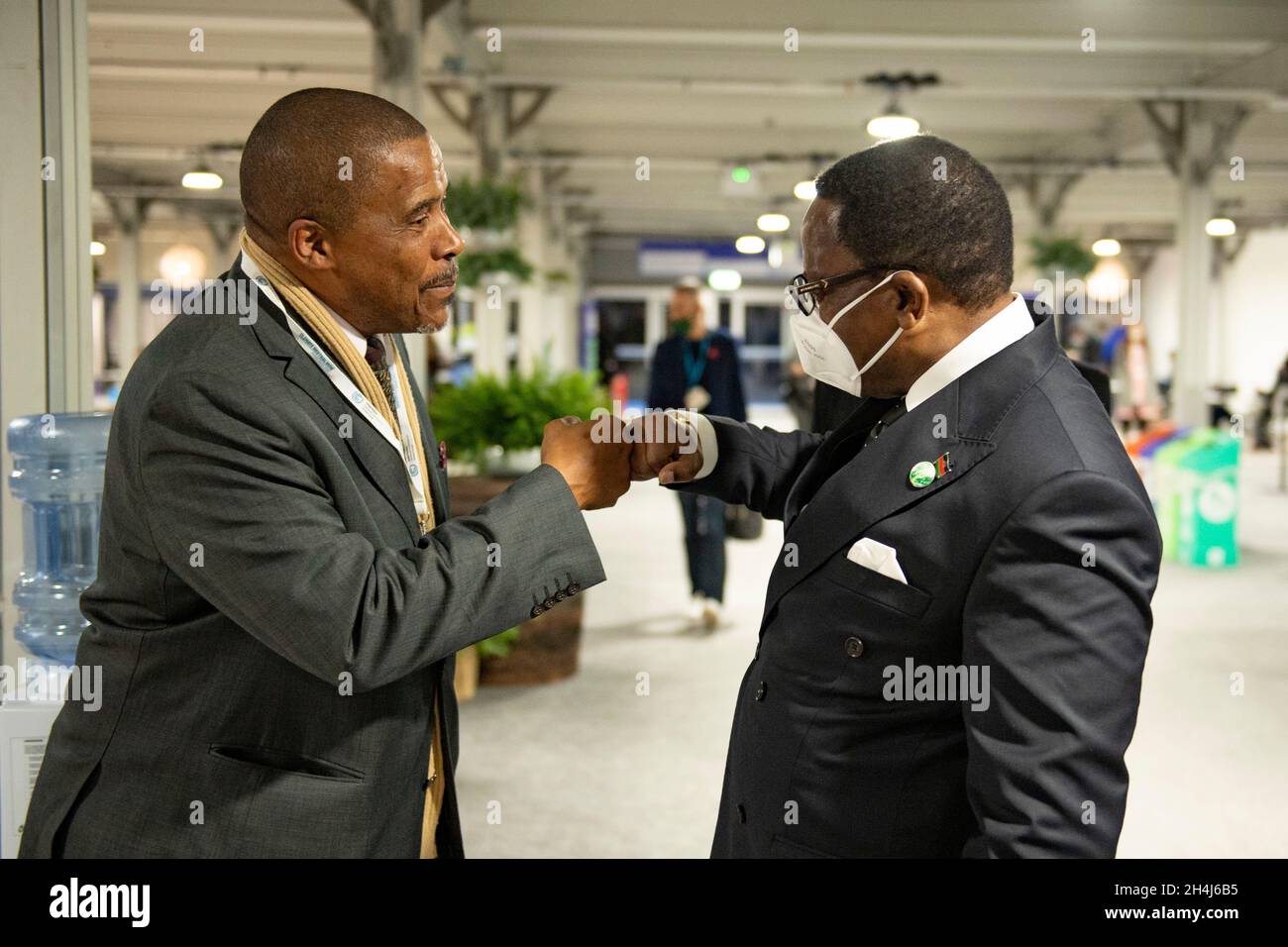 Glasgow, Scotland, UK. 2 November 2021 PICTURED: (right) President Lazarus Chakwera, President of Malawi seen at COP26 fist pumping a delegate. The president of the Republic of Malawi (Chichewa: Mtsogoleri wa Dziko la Malawi) is the head of state and head of government of Malawi. The president leads the executive branch of the Government of Malawi and is the commander-in-chief of the Malawian Defence Force. The current president is Lazarus Chakwera, who defeated Peter Mutharika in the 2020 rerun presidential election. Chakwera was sworn in as president of Malawi on 28 June. Credit: Colin Fishe Stock Photo