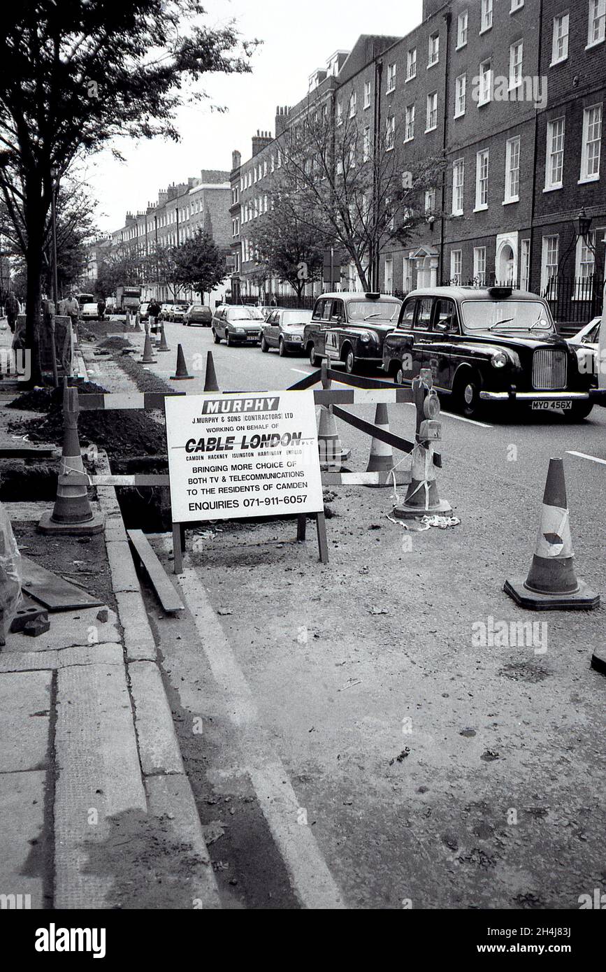 A trench dug in the road to lay cables for Cable London Limited in Camden, London on October 2, 1991. Stock Photo