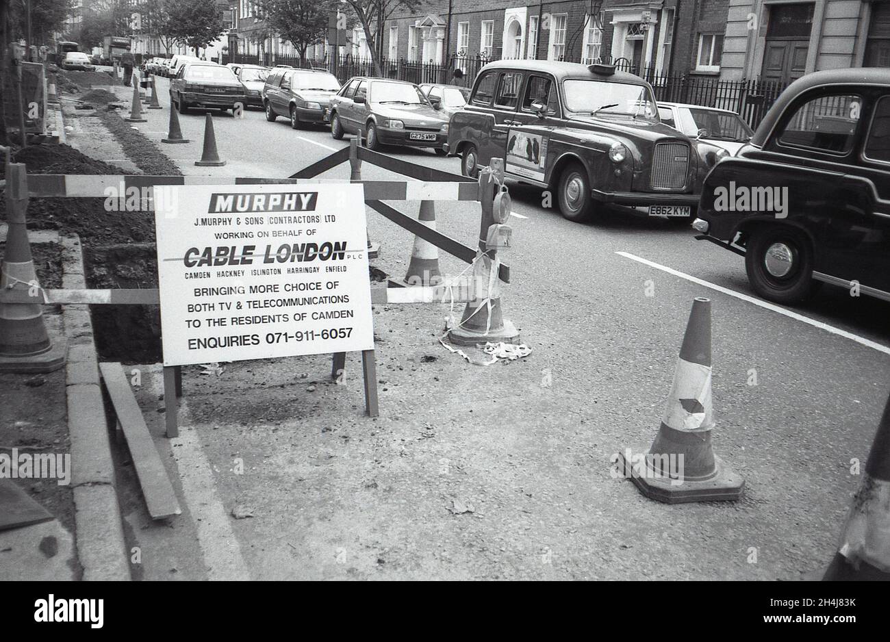 A trench dug in the road to lay cables for Cable London Limited in Camden, London on October 2, 1991. Stock Photo