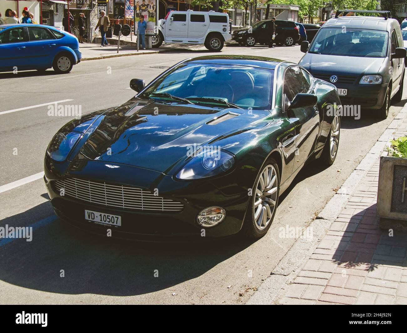 Kiev, Ukraine - May 14, 2011: English supercar Aston Martin Vanquish in the city. Green Aston Martin Stock Photo