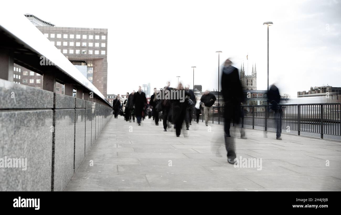 Business Blur. Creative abstract view of pedestrian commuter traffic crossing London Bridge during early morning rush hour. Stock Photo