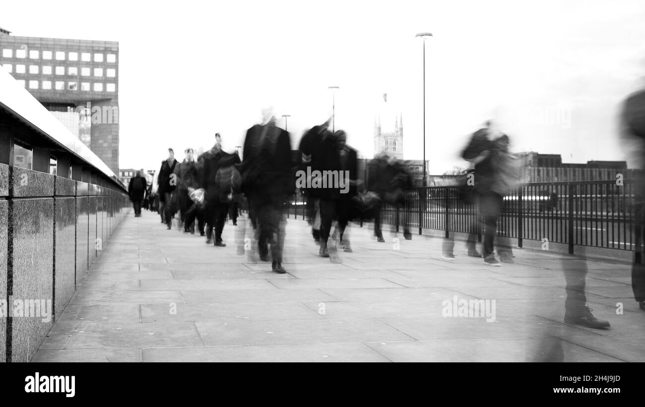 The Speed of Business. Creative abstract view of pedestrian commuter traffic crossing London Bridge during early morning rush hour. Stock Photo