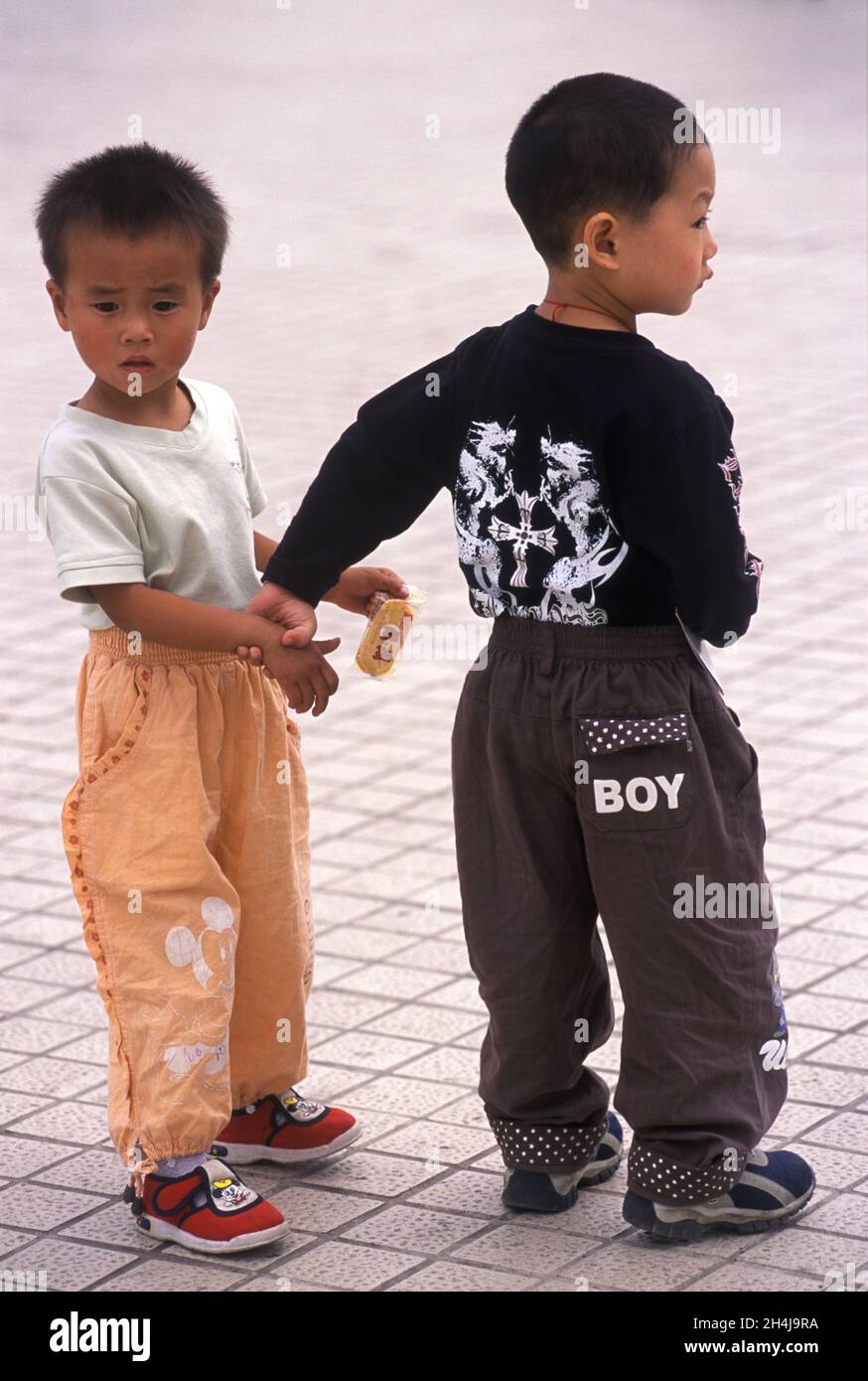 China 2000s. Two young Chinese boys wearing western style designer label clothes. On the trousers of one of them is the logo 'Boy'. Hangzhou, Zhejiang Province, China. 2000s, 2001  HOMER SYKES. Stock Photo