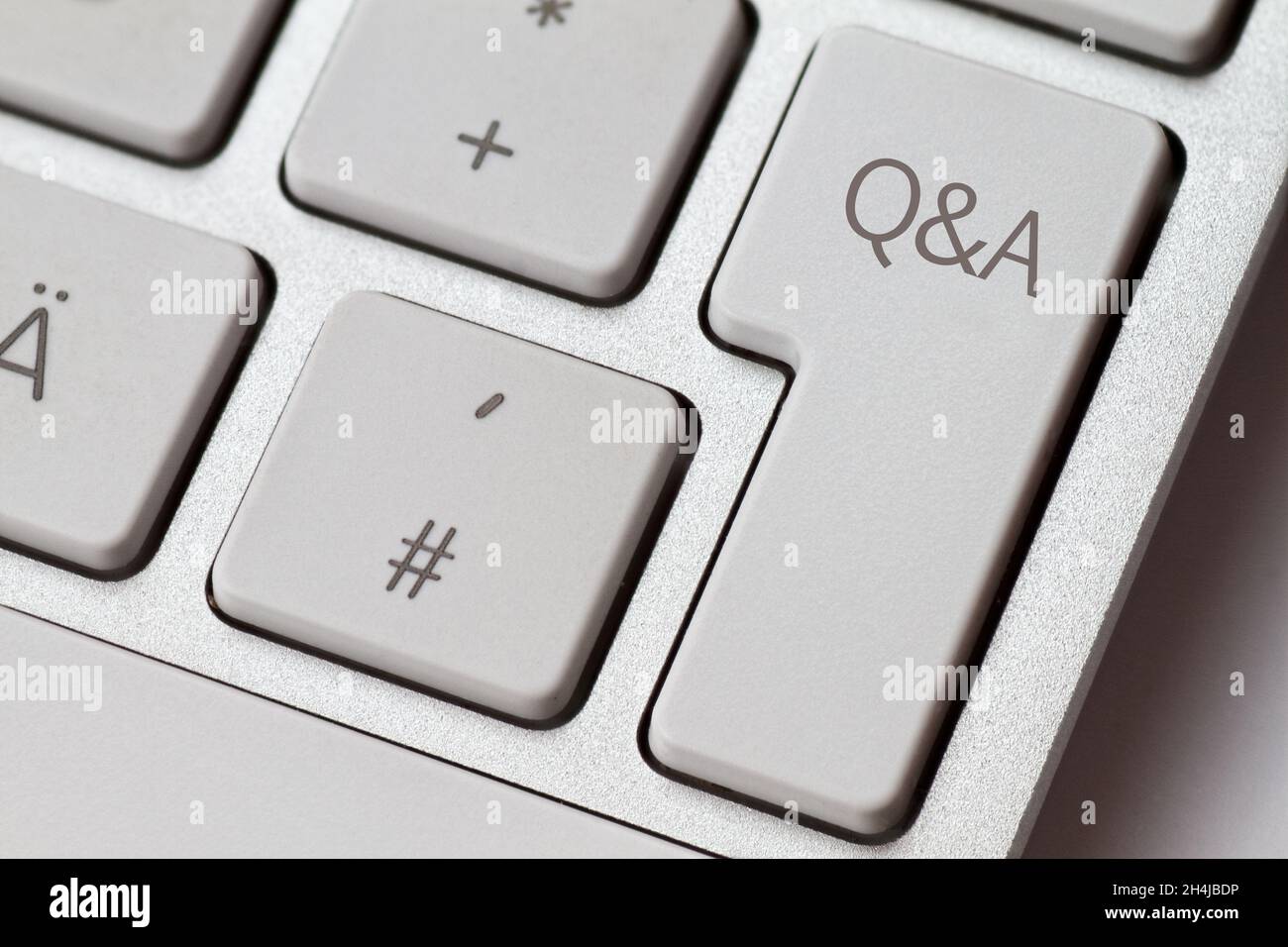 Q&A as an abbreviation on an aluminum keyboard from a computer Stock Photo