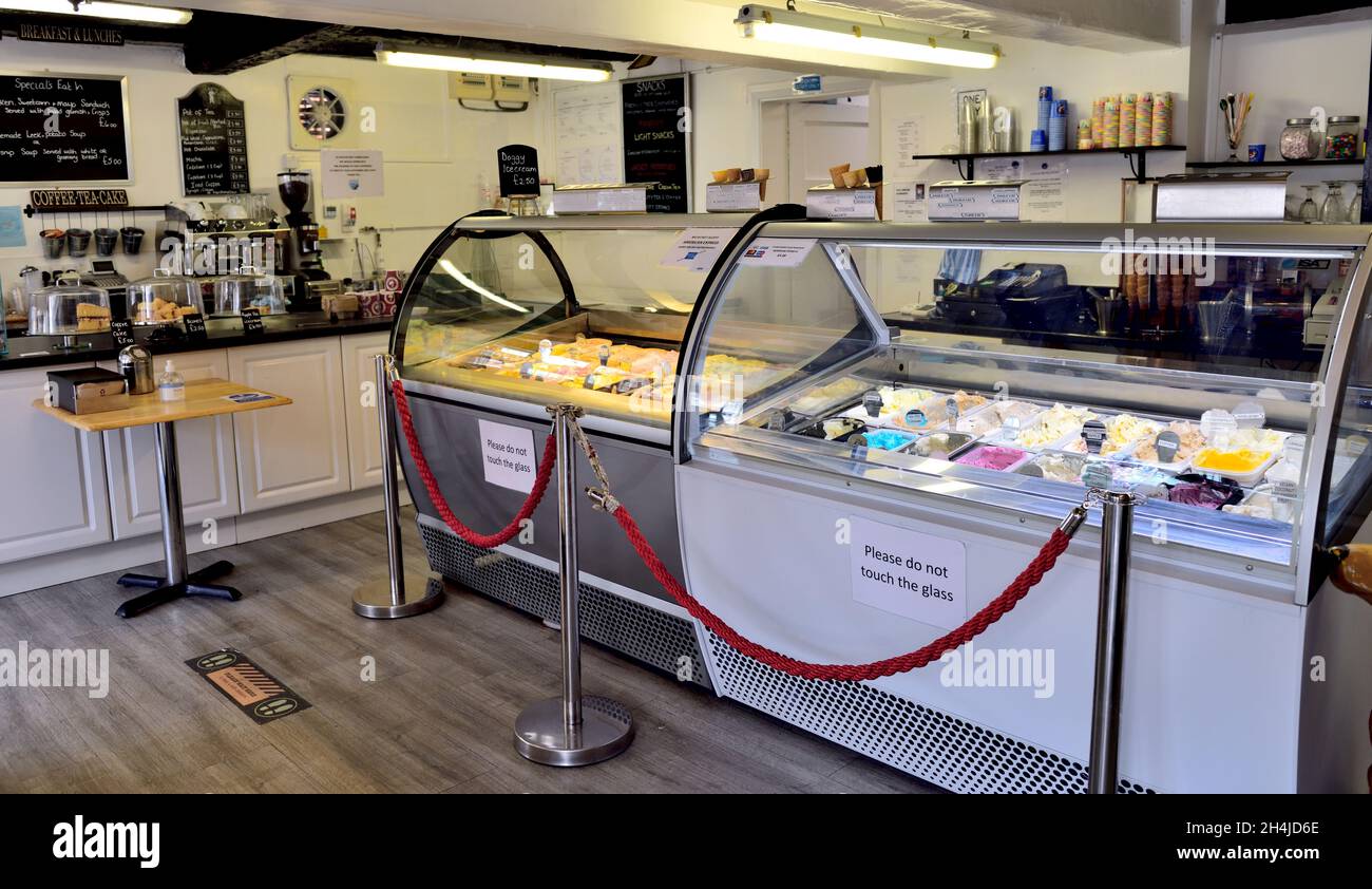 Inside historic ice cream counter in Henley-in-Arden high street serving customer double cone of ice-cream, UK Stock Photo