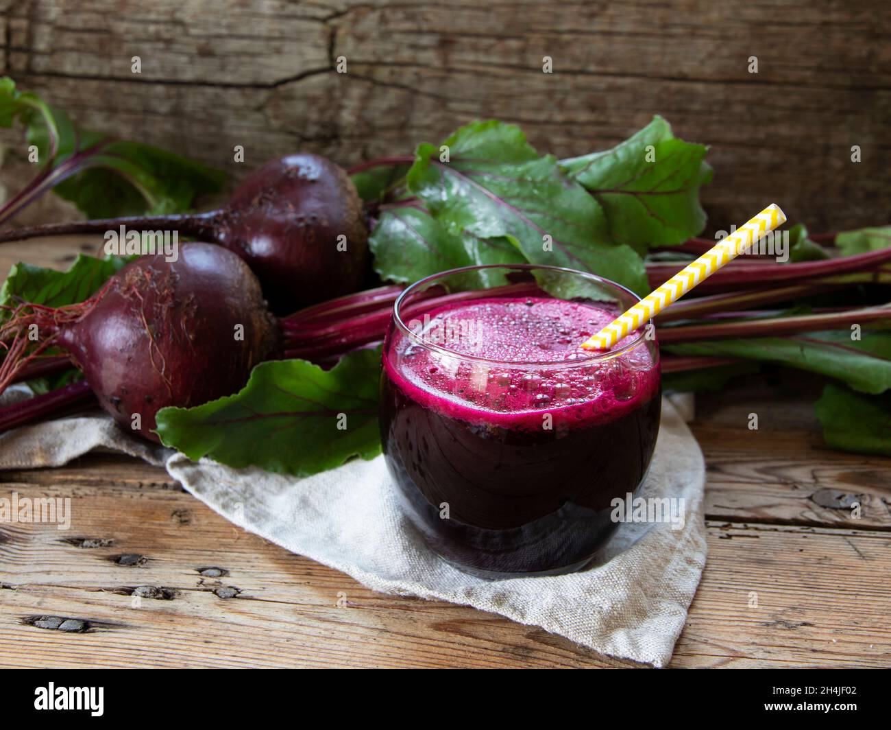 Fresh smoothie squeezed  beetroot juice in a glass on a wooden surface Stock Photo