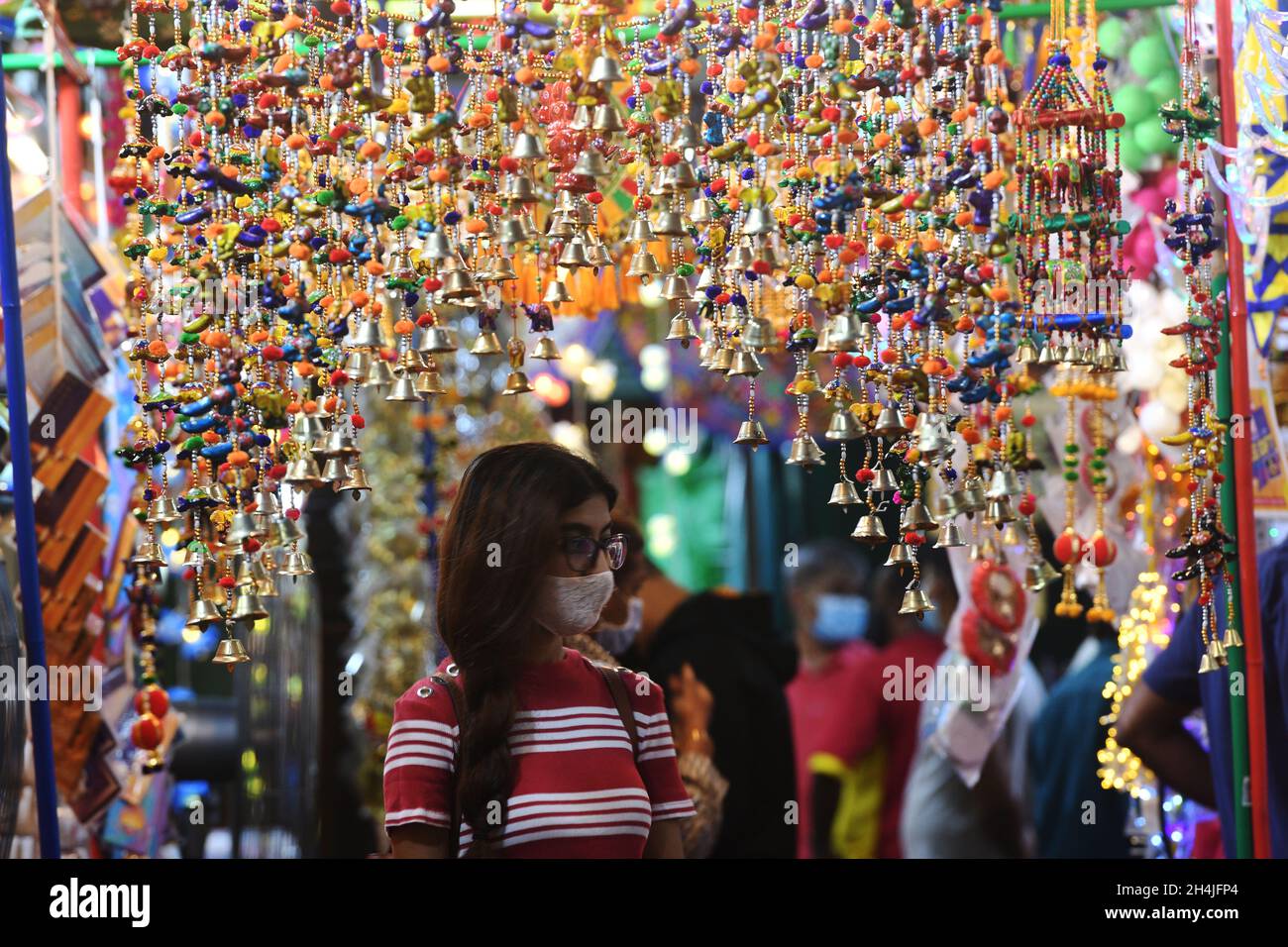 Singapore. 3rd Nov, 2021. A woman shops for Deepavali decorations in Singapore's Little India on Nov. 3, 2021. Credit: Then Chih Wey/Xinhua/Alamy Live News Stock Photo