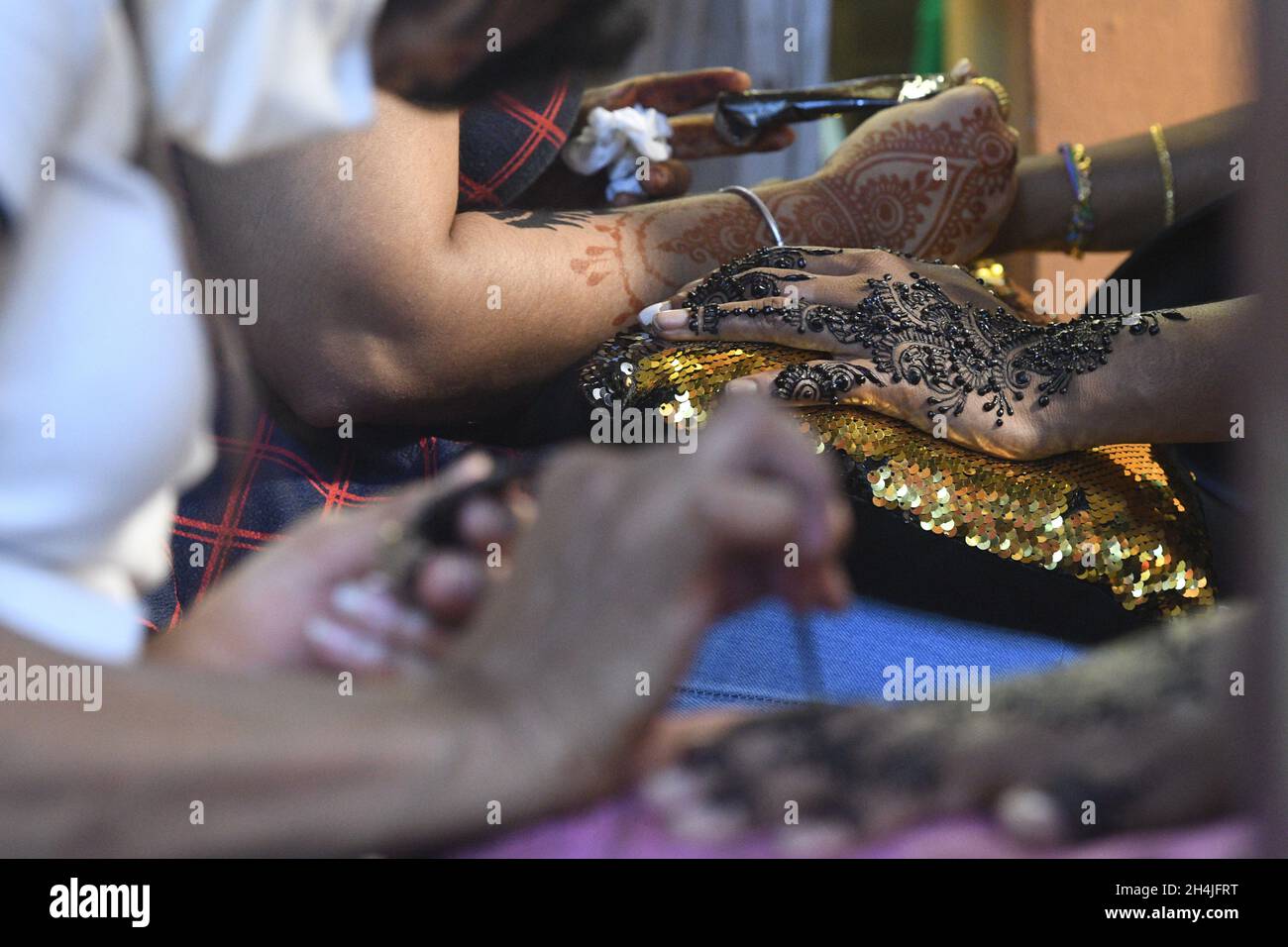 Singapore. 3rd Nov, 2021. Women get their henna tattoos done for Deepavali celebrations in Singapore's Little India on Nov. 3, 2021. Credit: Then Chih Wey/Xinhua/Alamy Live News Stock Photo