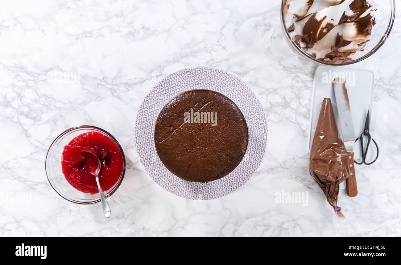 Flat lay. Covering chocolate cake with a crumb layer of chocolate