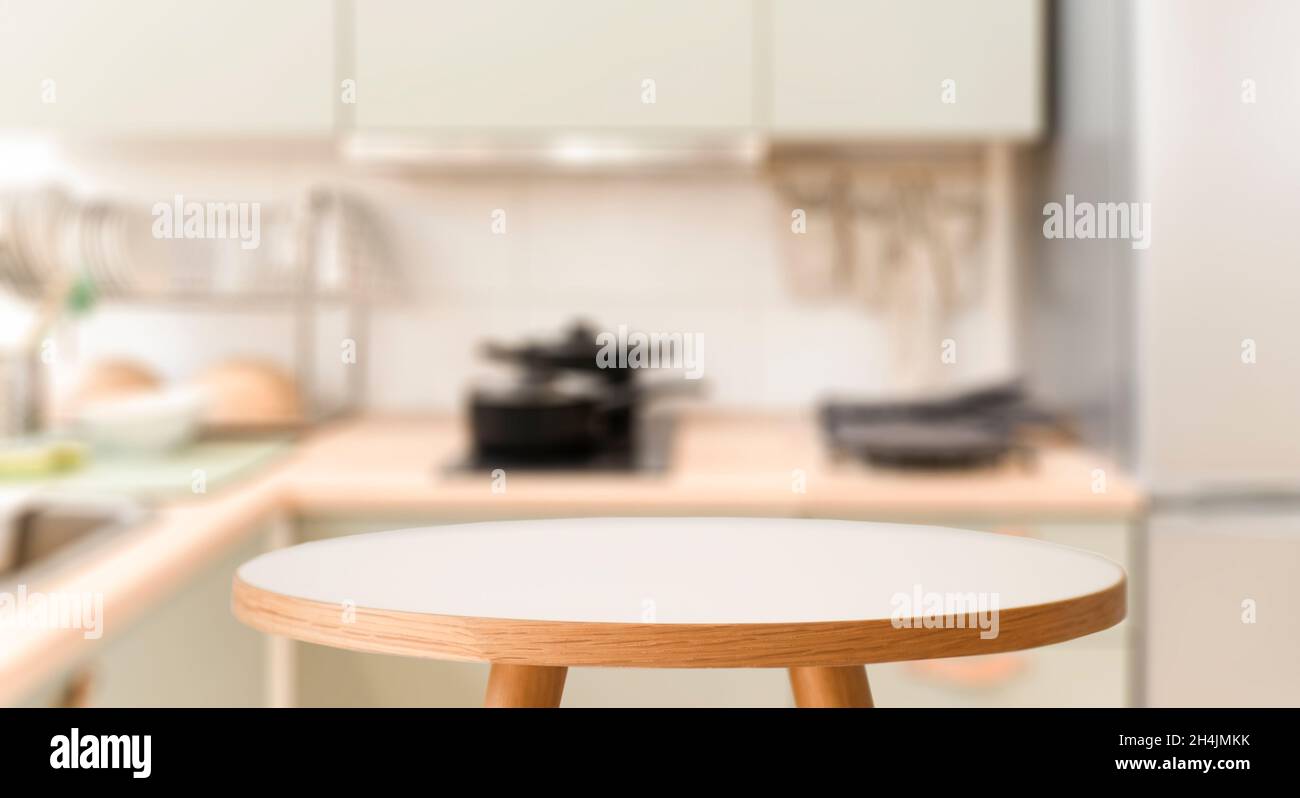 Kitchen table background. Wooden table in the interior of a home kitchen during the day. Food, cooking, groceries mockup. High quality photo Stock Photo