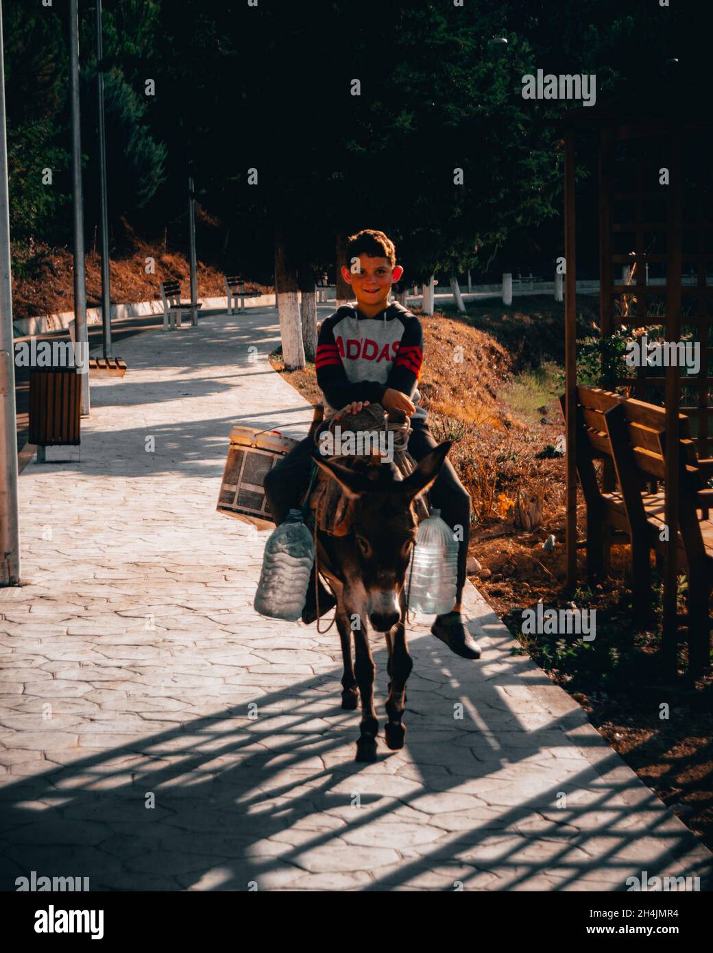 young village boy riding a donkey Stock Photo