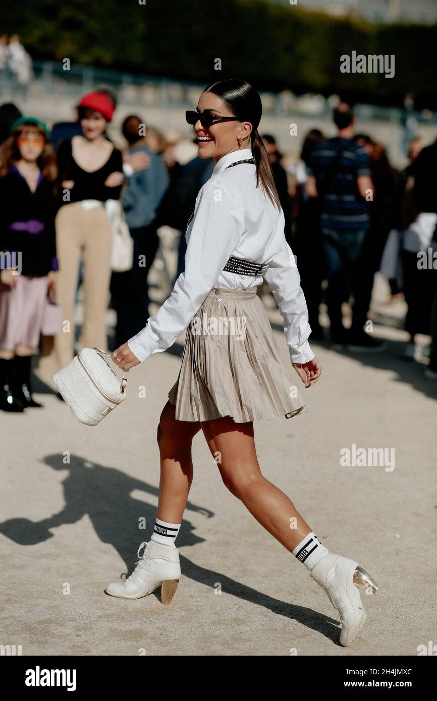 Camila Coelho in Miu Miu (dress and corduroy jacket) on the way to the  brand's runway show at Paris Fashion Week.
