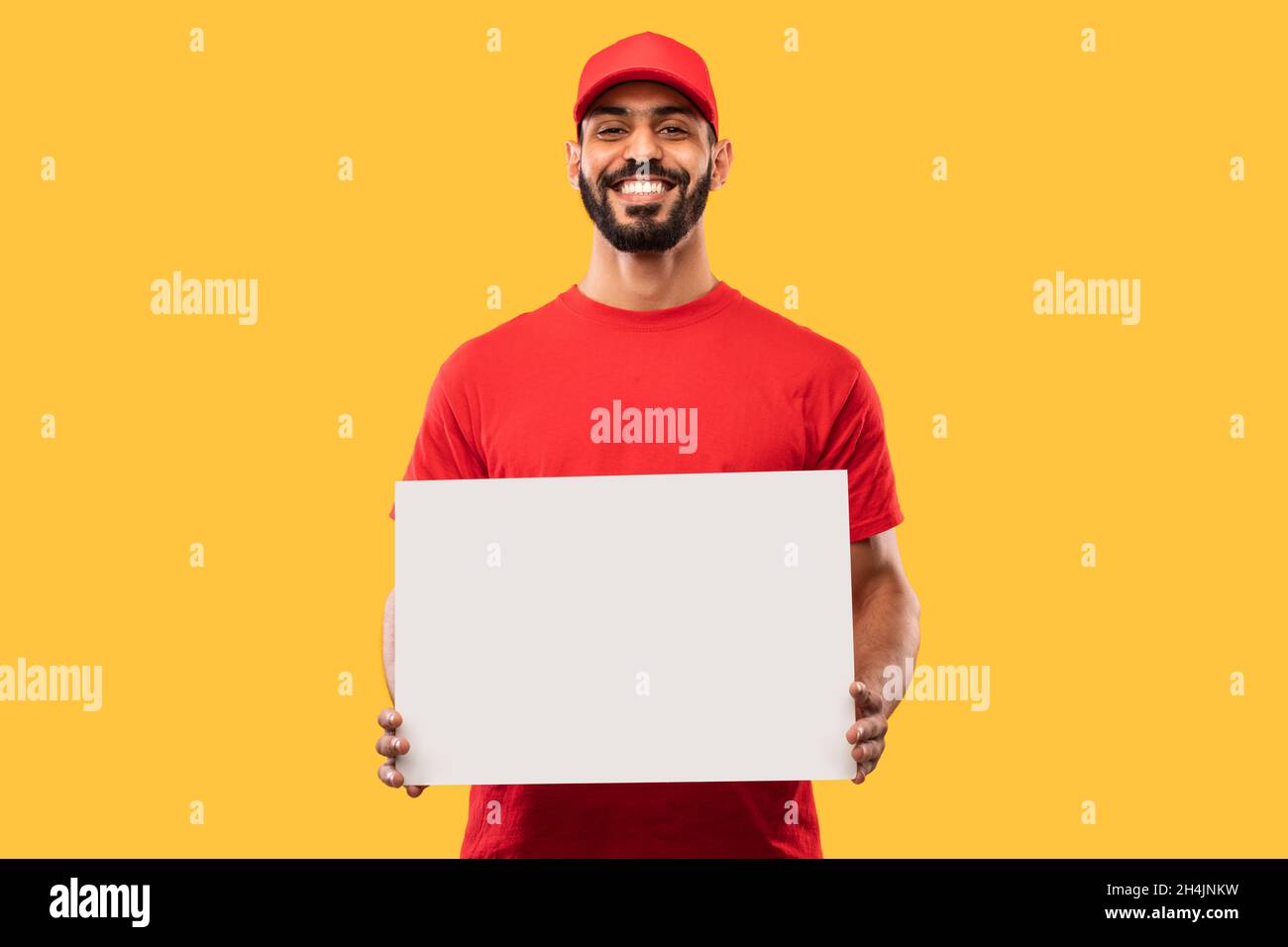 Cheerful Middle Eastern Courier Guy Showing Blank Paper Board