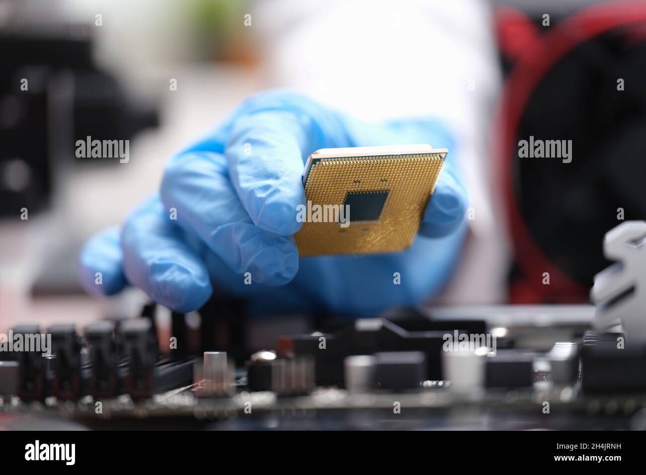 Repairman installing computer processor into motherboard closeup Stock ...
