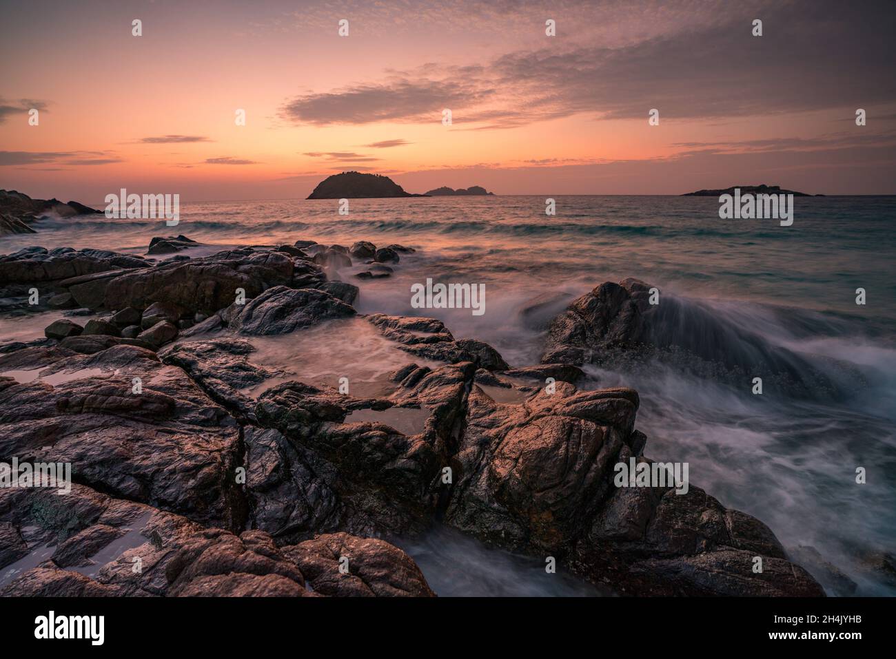 Rocky beach at sunrise, Redang Island, Terengganu, Malaysia Stock Photo