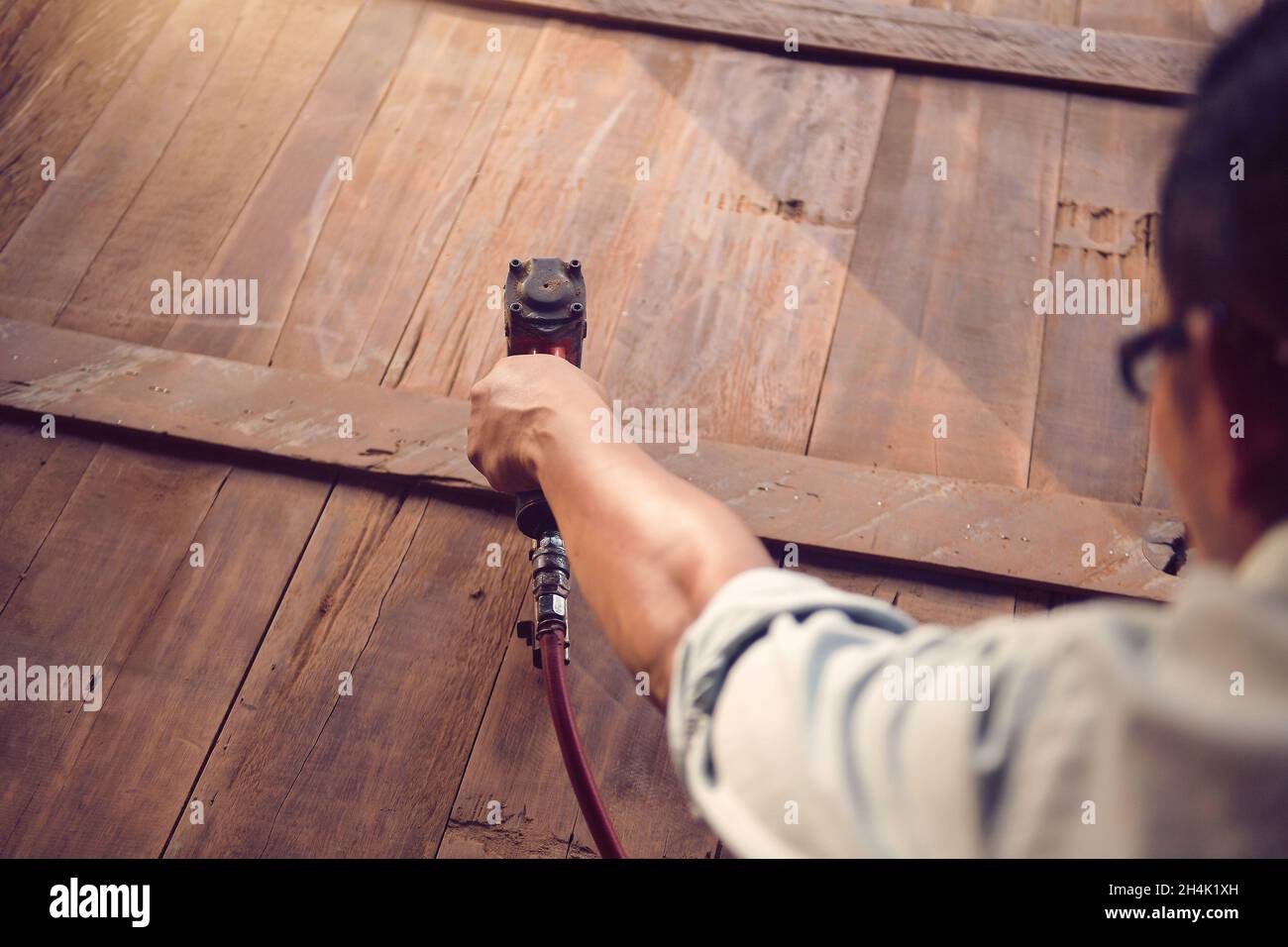 Close-up of a carpenter making furniture using a nail gun Stock Photo