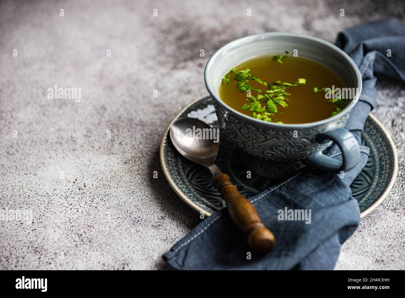 Bowl of healthy chicken broth with parsley Stock Photo