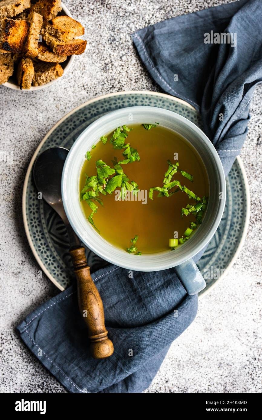 Bowl of healthy chicken broth with croutons and parsley Stock Photo