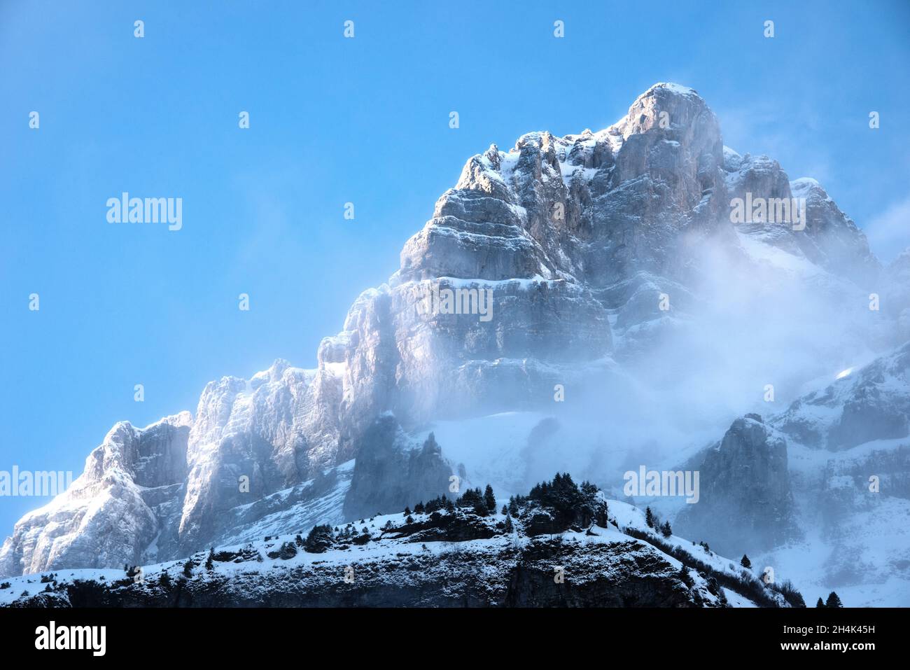 Snowcapped mountain peak covered in mist, Klausen, Switzerland Stock Photo