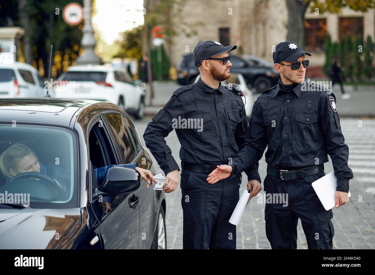 Police officer takes a bribe from a female driver Stock Photo Alamy