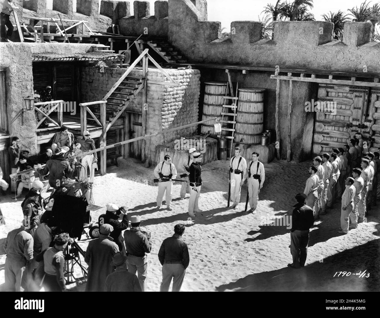HAROLD HUBER J. CARROL NAISH BRIAN DONLEVY GARY COOPER and RAY MILLAND on set candid with Camera / Movie Crew during filming of BEAU GESTE 1939 director WILLIAM A. WELLMAN novel P.C. Wren art direction Hans Dreier and Robert Odell music Alfred Newman costumes Edith Head Paramount Pictures Stock Photo