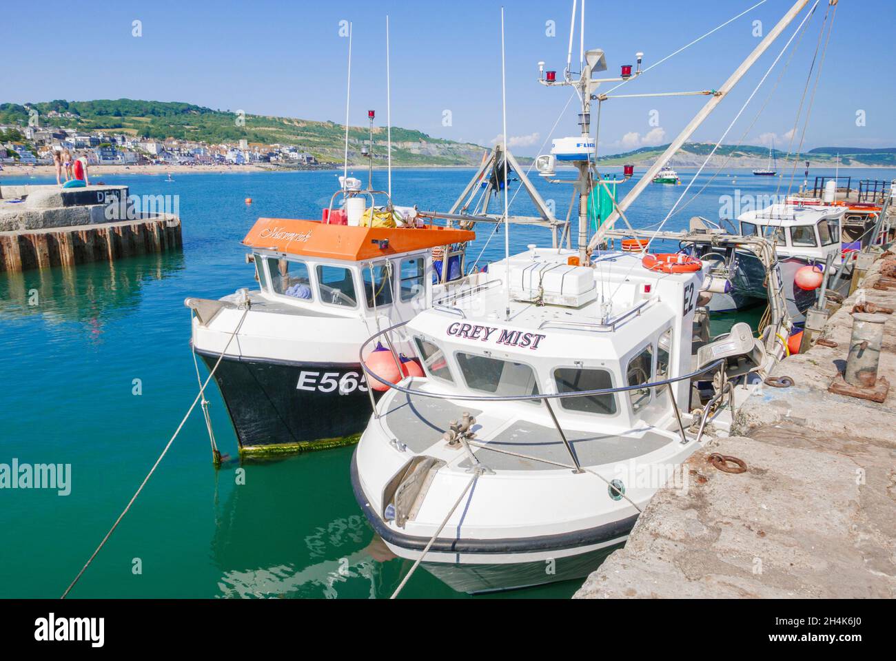 Fishing boats and Yachts in the Jurassic coast harbour with the Cobb
