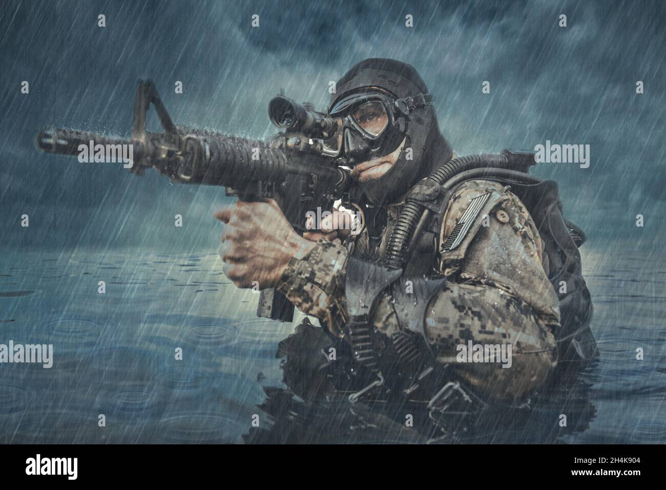 Navy SEAL frogman with complete diving gear and weapons in the water. Stock Photo