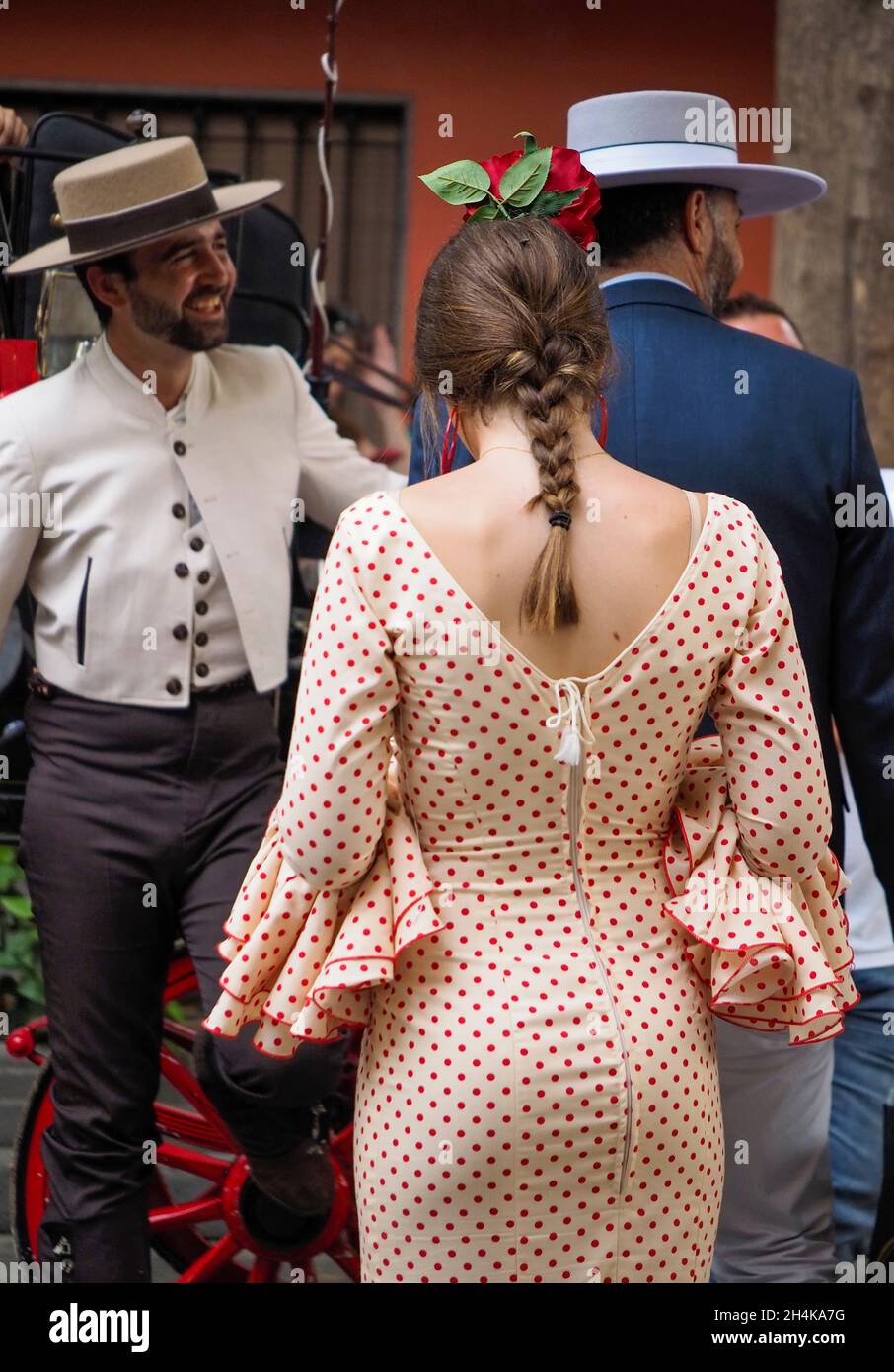 Back view of a young girl with a ponytail, wearing a typical flamenco dress. Stock Photo