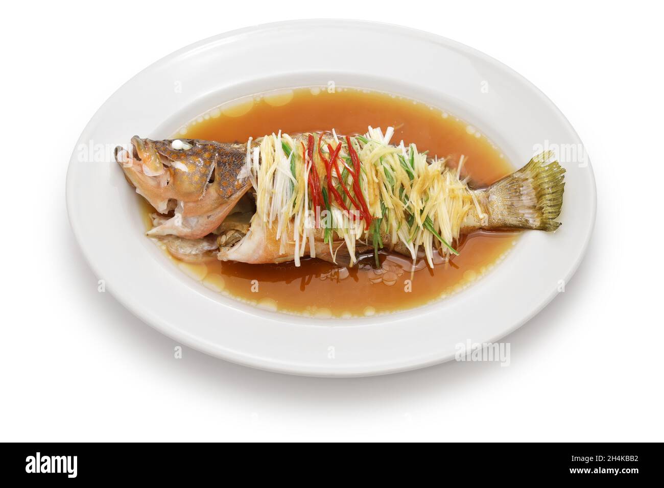 Chinese steamed whole Hong Kong grouper with scallion, ginger, and soy sauce Stock Photo