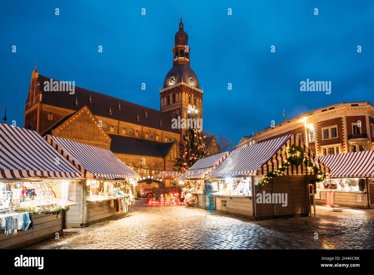 Riga, Latvia. Christmas Market On Dome Square With Riga Dome Cathedral.  Christmas Tree And Trading Houses. Famous Landmark At Winter Xmas Evening  Stock Photo - Alamy