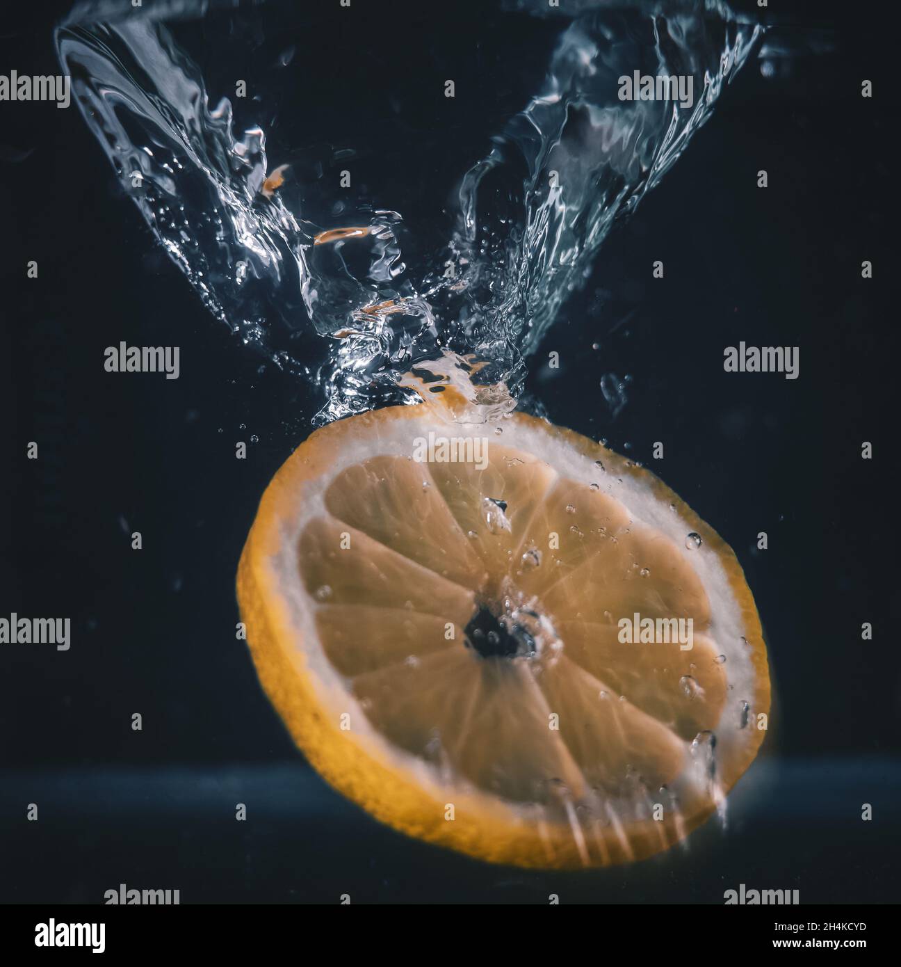 Closeup shot of an orange slice splashing in water Stock Photo - Alamy