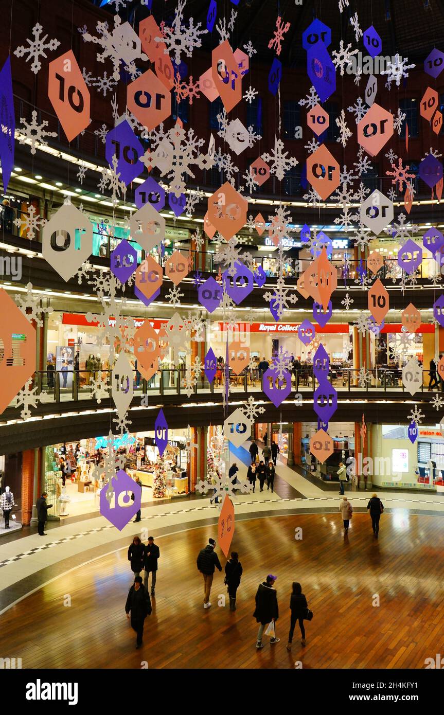 POZNAN, POLAND - Oct 10, 2013: A vertical shot of hanging decorations in a Stary Browar shopping mall with walking people in Poznan, Poland Stock Photo
