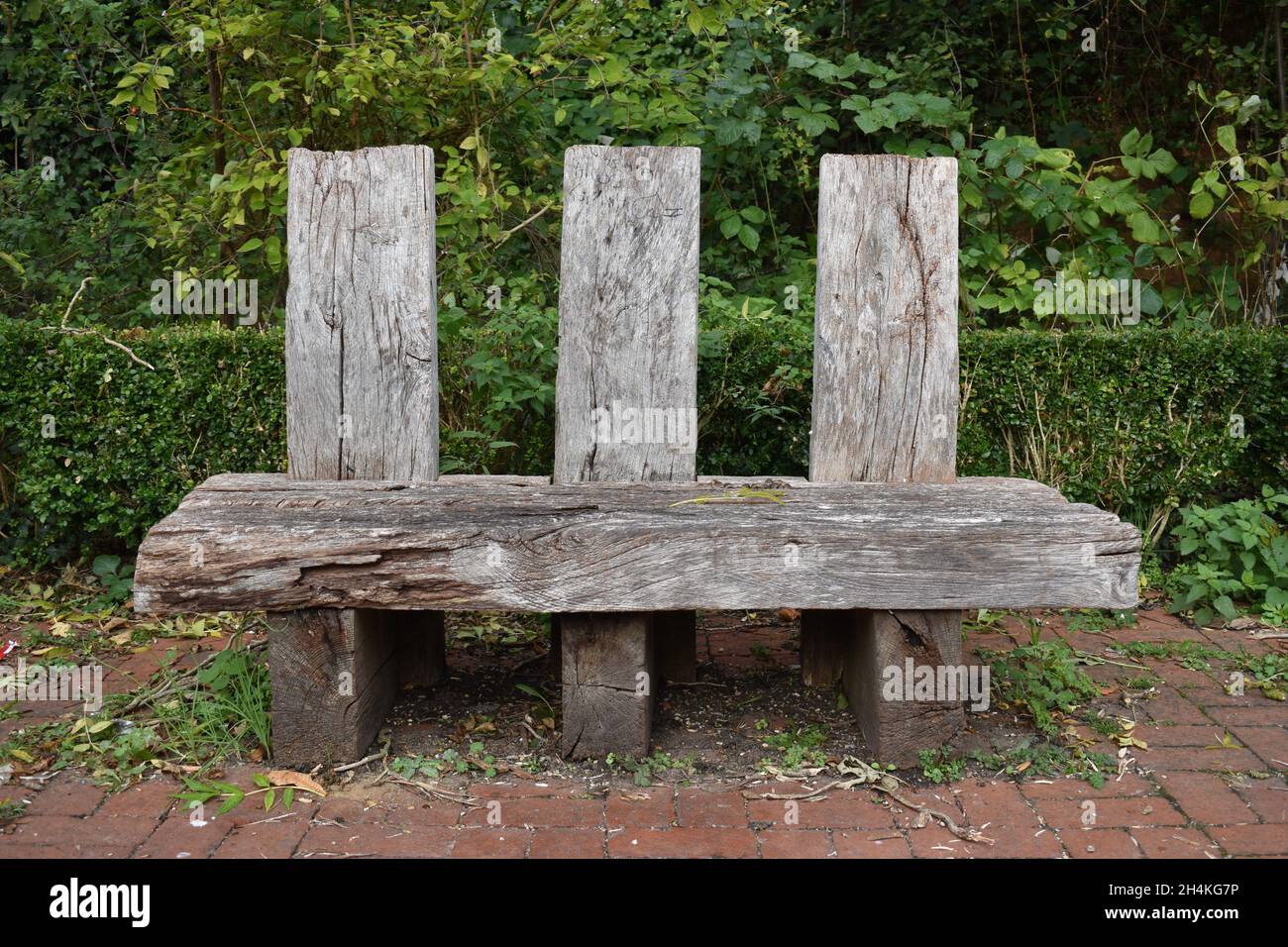 Rustic bench in the Secret Garden in Wolverton in Milton Keynes. Stock Photo