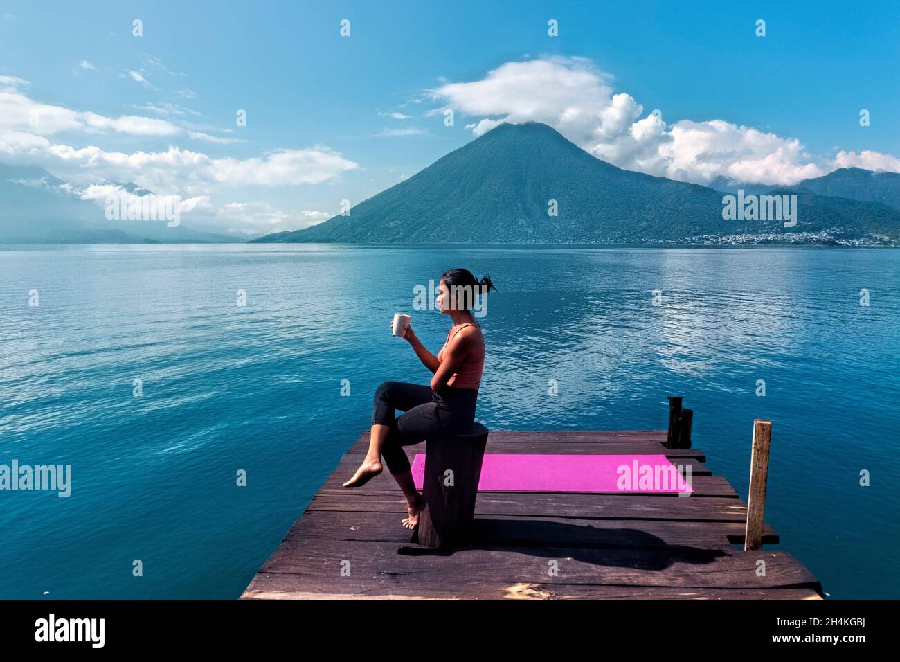 Morning coffee on the dock, San Marcos, Lake Atitlan, Guatemala. Stock Photo